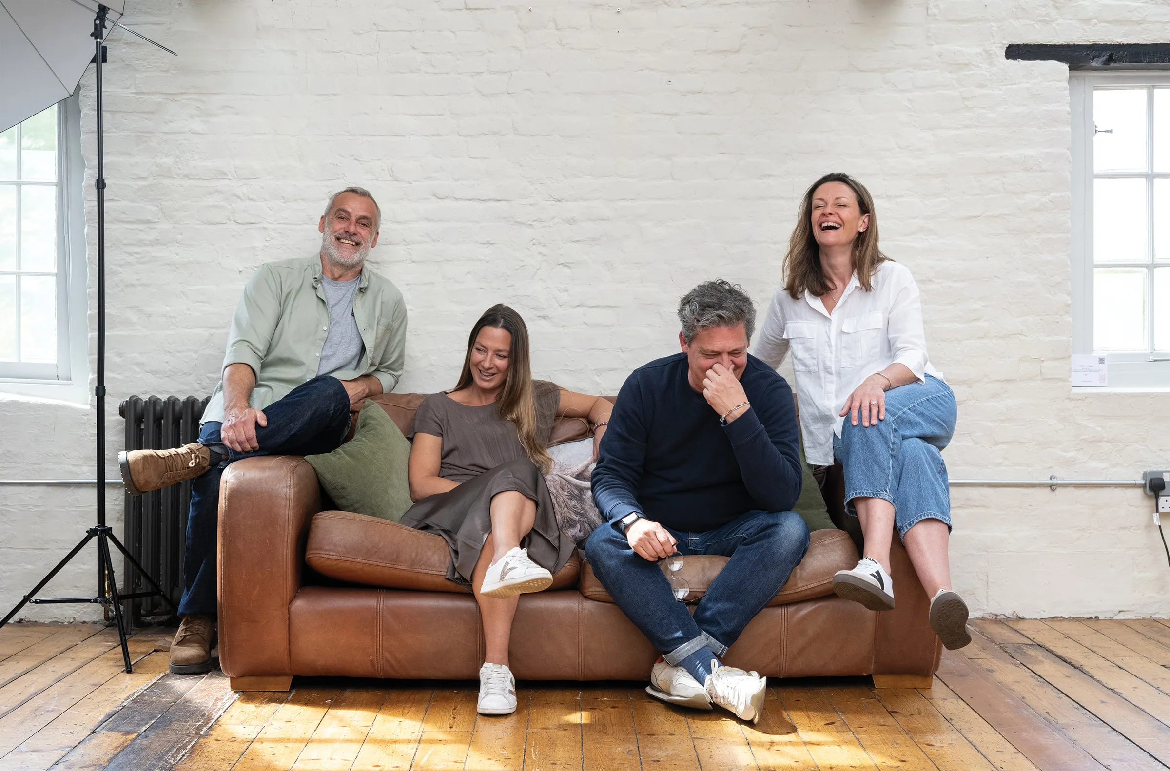 The Curation team gathered on a sofa in their studio