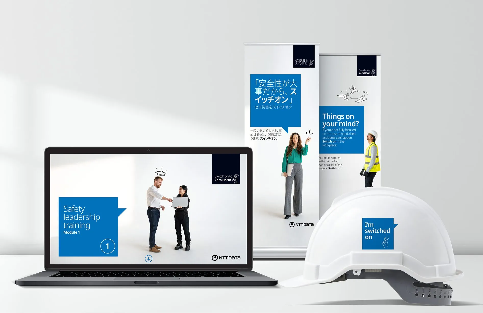 Global data center co behavioural-change campaign assets, including a laptop, posters and a hard hat