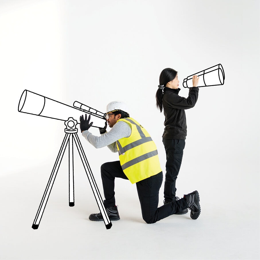 Two workers in hi-vis with a telescope