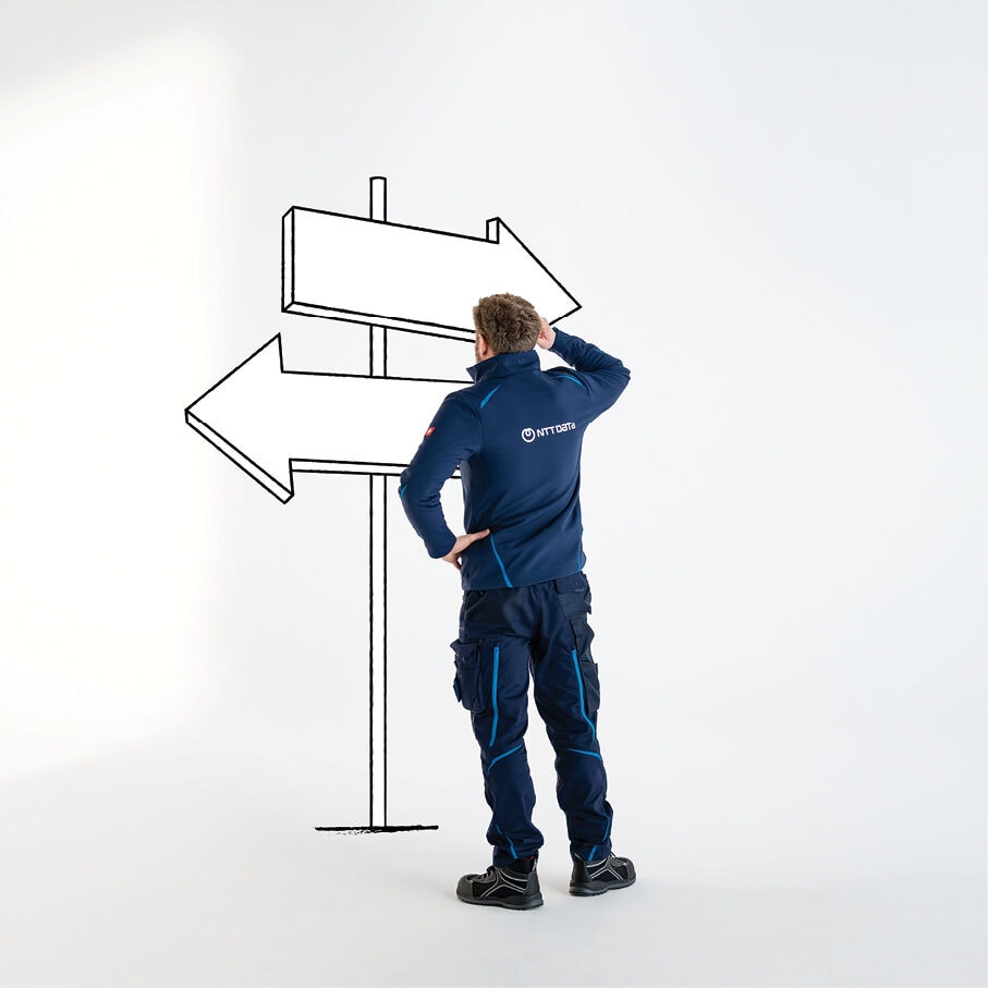 A worker beside a directional signpost