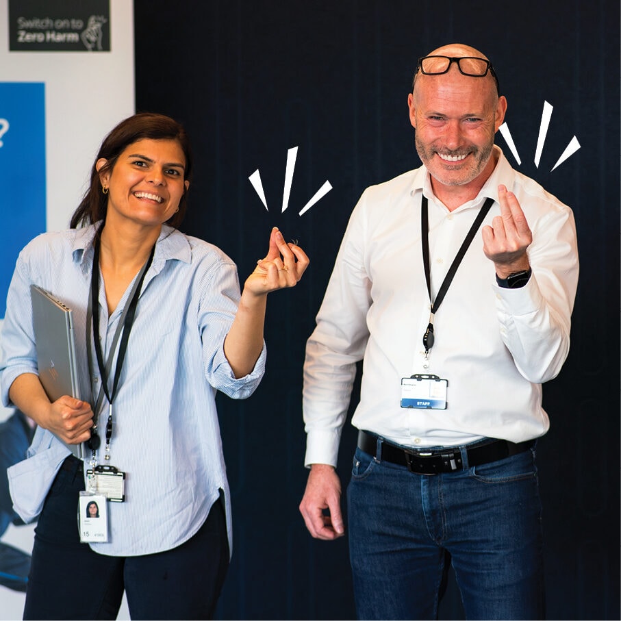 Two colleagues making the finger-click gesture