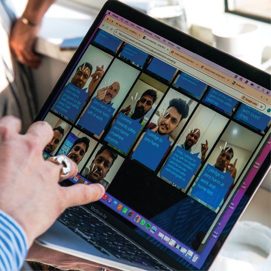 A hand interacting with the selfie pledge wall on a tablet